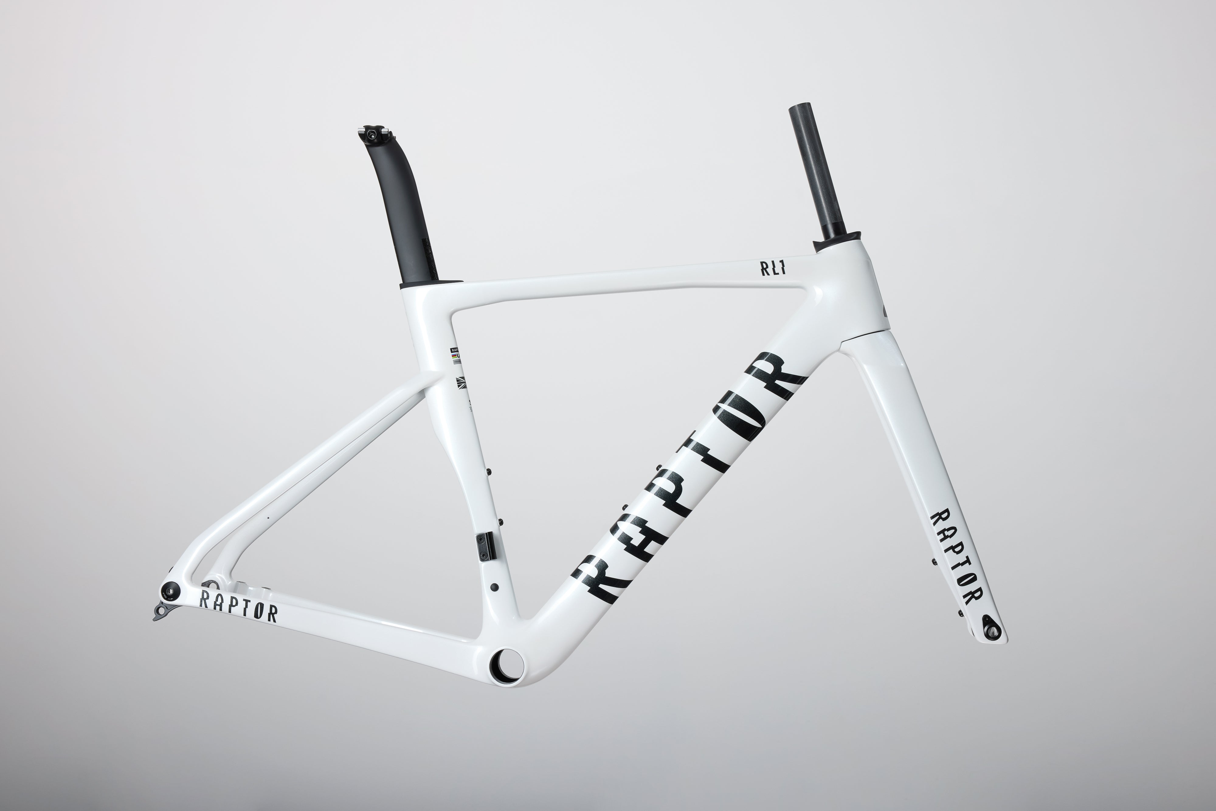 White bicycle frame with 'Raptor' branding on a gray background
